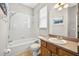 Bathroom features a shower over the tub and vanity with neutral cabinets, and tile flooring at 19028 Narimore Dr, Land O Lakes, FL 34638