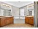 Bright bathroom with dual sinks, large tub, and tile floors at 19028 Narimore Dr, Land O Lakes, FL 34638