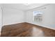 Bright, empty bedroom with hardwood floors and a window at 19028 Narimore Dr, Land O Lakes, FL 34638