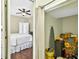 View of the bedroom with ceiling fan, wood floors and white comforter with a neutral color scheme at 19028 Narimore Dr, Land O Lakes, FL 34638