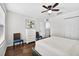Comfortable bedroom with white bedding and a ceiling fan at 19028 Narimore Dr, Land O Lakes, FL 34638