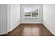 Cozy bedroom with wood floors and natural light from the window at 19028 Narimore Dr, Land O Lakes, FL 34638