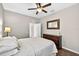 Comfortable bedroom with a dark wood dresser, ceiling fan, and hardwood floors at 19028 Narimore Dr, Land O Lakes, FL 34638
