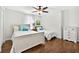 Bedroom featuring two beds, wood floors, natural lighting and neutral walls at 19028 Narimore Dr, Land O Lakes, FL 34638