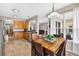 Dining area connecting to kitchen featuring a wooden table and view of backyard at 19028 Narimore Dr, Land O Lakes, FL 34638