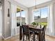 Cozy dining area with view to backyard featuring a wooden table and lots of light at 19028 Narimore Dr, Land O Lakes, FL 34638