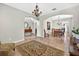 Open dining room with tile floors, a modern chandelier and neutral-colored walls at 19028 Narimore Dr, Land O Lakes, FL 34638