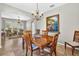 Elegant dining room showcasing a chandelier and tiled flooring at 19028 Narimore Dr, Land O Lakes, FL 34638