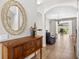 Inviting entryway featuring tile floors, a wooden console table and an arched doorway at 19028 Narimore Dr, Land O Lakes, FL 34638
