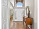 Inviting entryway featuring tile floors, a wooden console table and a partially-viewed living room at 19028 Narimore Dr, Land O Lakes, FL 34638