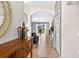 Inviting entryway featuring tile floors, a wooden console table and an arched doorway at 19028 Narimore Dr, Land O Lakes, FL 34638