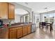 Bright kitchen with stainless steel appliances, wood cabinets, and open dining area at 19028 Narimore Dr, Land O Lakes, FL 34638