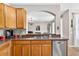 Cozy kitchen features stainless steel appliances, wood cabinets, and an adjacent dining area at 19028 Narimore Dr, Land O Lakes, FL 34638