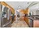 Open kitchen with stainless steel appliances and wood cabinetry at 19028 Narimore Dr, Land O Lakes, FL 34638