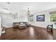 Living room featuring wood floors, natural lighting, and a view of the loft above with stairs at 19028 Narimore Dr, Land O Lakes, FL 34638