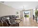 Spacious living room with tile floors, a chandelier, and glass doors leading to the backyard at 19028 Narimore Dr, Land O Lakes, FL 34638