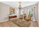 Cozy living room with two chairs, a rug, neutral walls and two windows that provide natural light at 19028 Narimore Dr, Land O Lakes, FL 34638