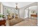 Cozy living room, neutral walls, rug, two chairs and an archway leading to the entry of the house at 19028 Narimore Dr, Land O Lakes, FL 34638