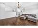 Living room featuring wood floors, access to the loft, a gray couch and staircase at 19028 Narimore Dr, Land O Lakes, FL 34638