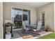 View of a covered patio that has a table and chairs on a decorative outdoor rug, a cozy space to relax at 19028 Narimore Dr, Land O Lakes, FL 34638