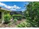 Exterior of home with a screened-in patio, offering a view of the well-maintained backyard and greenery at 21248 Diamonte Dr, Land O Lakes, FL 34637