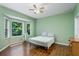 Bright bedroom with hardwood floors, large windows, and a ceiling fan, offering ample natural light at 21248 Diamonte Dr, Land O Lakes, FL 34637