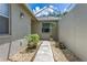 Charming courtyard with stone pathway and decorative plants, creating a welcoming entrance at 21248 Diamonte Dr, Land O Lakes, FL 34637