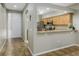 Bright kitchen featuring wood cabinets, stainless steel appliances, and a breakfast bar overlooking the foyer at 21248 Diamonte Dr, Land O Lakes, FL 34637