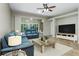 Inviting living room featuring tile flooring, ceiling fan, and sliding glass doors to outdoor space at 21248 Diamonte Dr, Land O Lakes, FL 34637