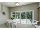Enclosed patio space with ceiling fan and sliding glass doors, perfect for outdoor relaxation or dining at 21248 Diamonte Dr, Land O Lakes, FL 34637