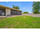 View of screened-in lanai, bright green grass, and partial privacy wall in back yard at 2131 Ridge S Rd # 19, Largo, FL 33778
