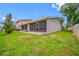 Backyard featuring a large screened patio and green grass at 2131 Ridge S Rd # 19, Largo, FL 33778