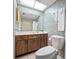 Well-lit bathroom with floral wallpaper, vanity, skylight, and a commode at 2131 Ridge S Rd # 19, Largo, FL 33778