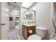 Hall bathroom with a skylight, single sink vanity, and a view into the kitchen at 2131 Ridge S Rd # 19, Largo, FL 33778