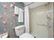 Compact bathroom with shower, toilet, and floral patterned wall paper at 2131 Ridge S Rd # 19, Largo, FL 33778
