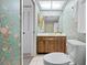 Bathroom featuring floral wallpaper, commode, vanity, shower and natural light at 2131 Ridge S Rd # 19, Largo, FL 33778