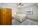 Cozy bedroom featuring a ceiling fan, window view, and a comfortable bed at 2131 Ridge S Rd # 19, Largo, FL 33778