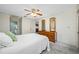 A well-lit bedroom featuring a bed, wooden dresser with mirror, and an ensuite bathroom at 2131 Ridge S Rd # 19, Largo, FL 33778