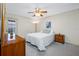 Inviting bedroom featuring a comfortable bed, wooden dresser, and a ceiling fan for a relaxing atmosphere at 2131 Ridge S Rd # 19, Largo, FL 33778