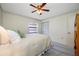 Bright bedroom featuring a ceiling fan, closet, and neutral decor for a relaxing retreat at 2131 Ridge S Rd # 19, Largo, FL 33778