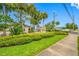 Coastal Ridge neighborhood sign with a view of tropical landscaping and a sidewalk at 2131 Ridge S Rd # 19, Largo, FL 33778