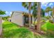 Lawn view of building exterior showcasing a screened-in patio and manicured landscaping at 2131 Ridge S Rd # 19, Largo, FL 33778