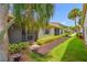 Building exterior showcases mulch walkway, lush landscaping, and a view of the screened-in patio at 2131 Ridge S Rd # 19, Largo, FL 33778