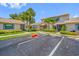An exterior view of the condo complex features lush landscaping and ample parking at 2131 Ridge S Rd # 19, Largo, FL 33778