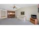 Open living room with an adjacent dining area, complete with a comfortable sofa and a television at 2131 Ridge S Rd # 19, Largo, FL 33778