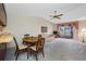 Cozy living room with a dining table, floral sofa, and a sliding glass door, enhanced by a ceiling fan at 2131 Ridge S Rd # 19, Largo, FL 33778