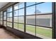 Enclosed patio with black-framed glass windows overlooking the backyard and garage at 2131 Ridge S Rd # 19, Largo, FL 33778