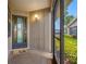 Inside the screened-in patio looking out to the yard, lawn, and complex at 2131 Ridge S Rd # 19, Largo, FL 33778