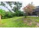 A well-maintained backyard with lush greenery and a birdhouse, offering a serene outdoor space at 2174 Kent Ave, Clearwater, FL 33764