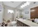 Bright bathroom with a tub-shower combo, single sink vanity and updated fixtures at 2174 Kent Ave, Clearwater, FL 33764
